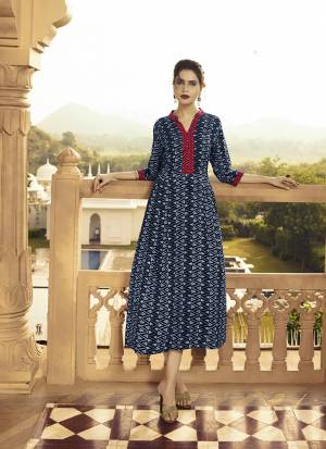 Add This Readymade Kurti To Your Wardrobe In Navy Blue Color Fabricated On Rayon. It Is Beautified With Checks Prints And Floral Thread Work. 