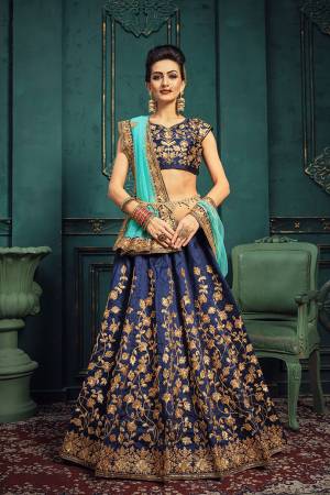 Get Ready For The Upcoming Wedding Season With This Beautiful and Attractive Looking Heavy Designer Lehenga Choli In Navy Blue Color Paired With Blue Colored Dupatta. This Lehenga Choli Is Silk Based Paired With Net Fabricated Dupatta. Buy Now.