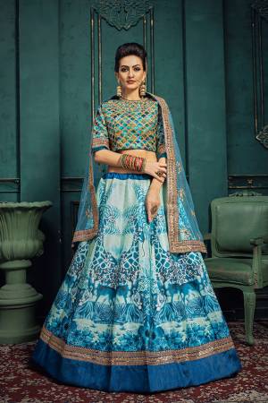 Here Is A Very Pretty Digital Printed Designer Lehenga Choli In Shades Of Blue. This Pretty Lehenga Choli Is Silk Based Paired With Net Fabricated Dupatta. It Is Light In Weight And Easy To Carry Throughout The Gala. 