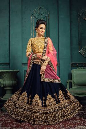 Go Colorful With This Attractive And Heavy Designer Lehenga Choli In Yellow Colored Blouse Paired With Navy Blue Colored Lehenga And Contrasting Pink Colored Dupatta. This Heavy Embroidered Lehenga Choli Is Fabricated On Velvet Paired With Net Fabricated Dupatta. Buy Now.