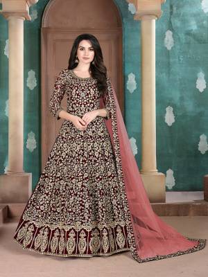 Get Ready For The Upcoming Wedding Season With This Attractive Looking Heavy Designer Floor Length Suit In Maroon Color. This Pretty Heavy Embroidered Suit Is Fabricated On Georgette Paired With Santoon Bottom And Net Fabricated Dupatta. Its Bright Color And Heavy Embroidery Will Give An Attractive Look To Your Personality. 