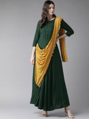 Look Pretty In This Readymade Designer Indo-Western Dress In Dark Green Color. This Pretty Dress Is Fabricated On Rayon Attached With A Pretty Musturd Yellow Dupatta With Lace Border. Its Fabric IS Soft Towards Skin And Ensures Superb Comfort All Day Long. 