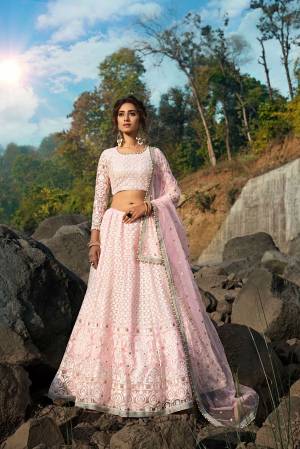 Get Ready For The Upcoming Wedding Season With This Very Beautiful Designer Lehenga Choli In Baby Pink Color. This Pretty Lehenga Choli Is Net Based Beautified With Detailed Attractive Embroidery. 