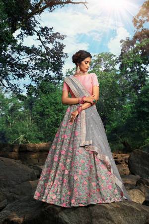 Look Pretty In This Lovely Pink And Grey Colored Designer Lehenga Choli. This Pretty Heavy Embroidered Lehenga Choli Is Net Based Which Is Light Weight And Easy To Carry Throughout The Gala.