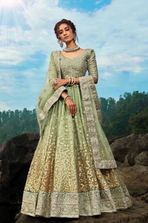 Flaunt Your Rich And Elegant Taste Wearing This Pretty Designer Lehenga Choli In All Over Pastel Green Color. Its Blouse Is Fabricated On Art Silk Paired With Net Fabricated Lehenga And Dupatta. It Is Beautified With Coding And Sequence Work. 