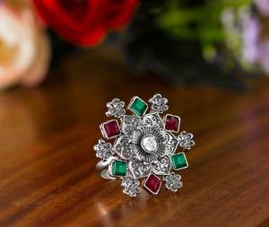 Here Is A Pretty Traditional Looking Ring In Silver Color In Oxidize Material. This Pretty Ring Is Beautified With Multi Color Stone Work And You Can Pair This Up With Any Colored Traditional Attire. Buy Now.