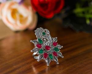 Here Is A Pretty Traditional Looking Ring In Silver Color In Oxidize Material. This Pretty Ring Is Beautified With Multi Color Stone Work And You Can Pair This Up With Any Colored Traditional Attire. Buy Now.