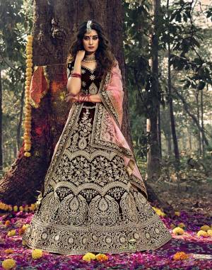 Here Is A Very Beautiful Heavy Designer Lehenga Choli For Bridal Wear In Dark Maroon Color Paired With Baby Pink Colored Dupatta. Its Blouse, Lehenga And Dupatta Are Beautified with Attractive Jari Embroidery And Stone Work. 