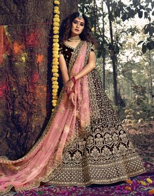 Here Is A Very Beautiful Heavy Designer Lehenga Choli For Bridal Wear In Dark Maroon Color Paired With Baby Pink Colored Dupatta. Its Blouse, Lehenga And Dupatta Are Beautified with Attractive Jari Embroidery And Stone Work. 