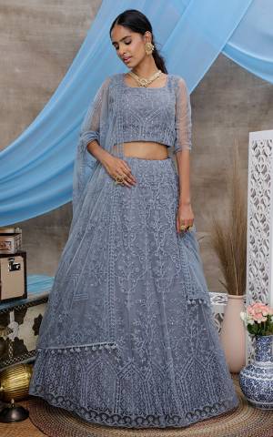 You Will Definitely Earn Lots Of Compliments Wearing This Heavy Designer Lehenga Choli In All Over Grey Color. Its Pretty Blouse, Lehenga and Dupatta Are Fabricated On Net Beautified with Tone To Tone Thread Embroidery And Stone Work. Buy This Elegant Peice Now.