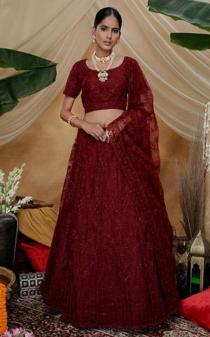 You Will Definitely Earn Lots Of Compliments Wearing This Heavy Designer Lehenga Choli In All Over Maroon Color. Its Pretty Blouse, Lehenga and Dupatta Are Fabricated On Net Beautified with Tone To Tone Thread Embroidery And Stone Work. Buy This Elegant Peice Now.