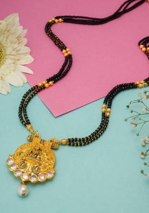 Grab This Double Chained Traditional Patterned Magalsutra Which Has An Attatched Pendant. This Mangalsutra Can Be Paired With Any Colored Traditional Attire And Suitable For Occasion Wear. Buy Now