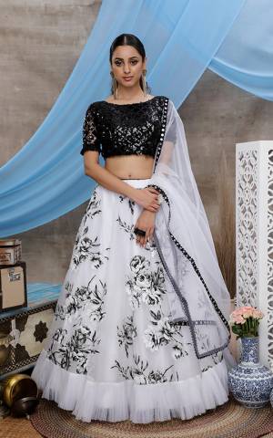 Grab This Beautiful Designer Lehenga Choli In Black And White Color. Its Heavy Sequence Embroidered Blouse Is Net Based Paired With Orgenza Fabricated Lehenga With Prints And Net Fabricated Dupatta. 