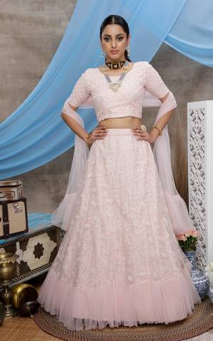 Look Pretty In This Lightest Shade Of Pink Colored Designer Lehenga Choli. This Pretty Piece Is Net Based Beautified With Elegant Tone To Tone Embroidery. 