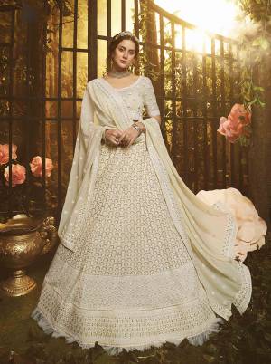 Look Like A Goddess Diva Wearing This Pretty Elegant Designer Lehenga Choli In Off-White Color. Its Blouse, Lehenga And Dupatta Are Georgette Based Beautified With Heavy Yet Subtle Looking Embroidery All Over. 