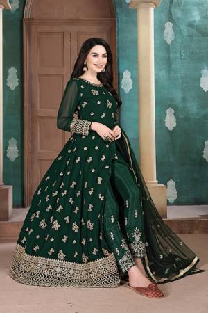 Here Is A Very Pretty Heavy Designer Indo-Western Suit In Dark Green Color. Its Emnbroidred Floor Length To Is Fabricated On Georgette Paired With Embroidered Bottom Fabricated On Santoon and Net Fabricated Dupatta. 