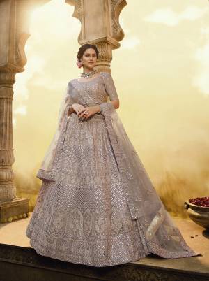 New And Unique Dusty shade In Purple Is Here With This Heavy Designer Lehenga Choli In Mauve Color. Its Blouse And Lehenga Are Crepe Based Paired With Net Fabricated Dupatta. 