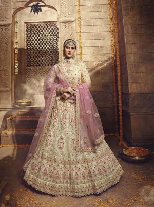 Rich And Elegant Looking Heavy Designer Lehenga Choli Is Here In Cream Color Paired With Baby Pink Colored Dupatta. This Pretty Lehenga Choli Is Orgenza Based Paired With Net Fabricated Dupatta. Buy Now.