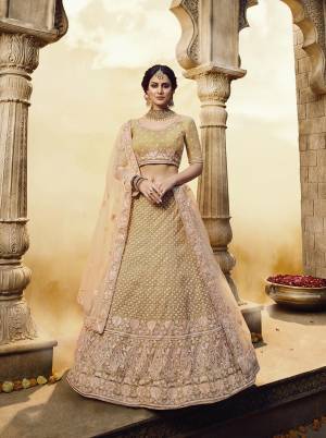 Look Attractive Wearing This Beautiful Heavy Designer Lehenga Choli In Golden Color Paired With Peach Colored Dupatta. Its Blouse And Lehenga Are Fabricated On Net With Gota Inner Paired With Net Fabricated Dupatta. Buy Now.