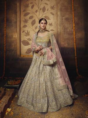 Look Attractive Wearing This Beautiful Heavy Designer Lehenga Choli In Olive Green Color Paired With Pastel Pink Colored Dupatta. Its Blouse And Lehenga Are Fabricated On Net With Gota Inner Paired With Net Fabricated Dupatta. Buy Now.