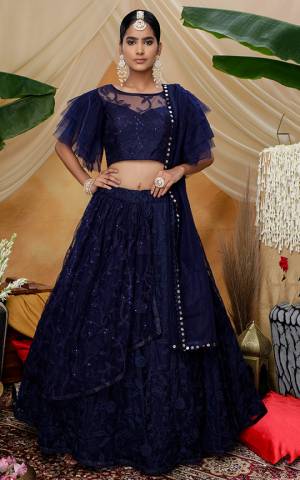 Here Is A Very Pretty Designer Lehenga Choli For The Upcoming Wedding Season In All Over Navy Blue Color. This Trendy Lehenga Choli Is Fabricated On Net Beautified With Heavy Yet Subtle Tone To Tone Embroidery. Buy This Lovely Piece Now.