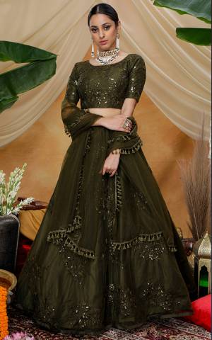 Here Is A Very Pretty Designer Lehenga Choli For The Upcoming Wedding Season In All Over Olive Green Color. This Trendy Lehenga Choli Is Fabricated On Net Beautified With Heavy Yet Subtle Tone To Tone Embroidery. Buy This Lovely Piece Now.