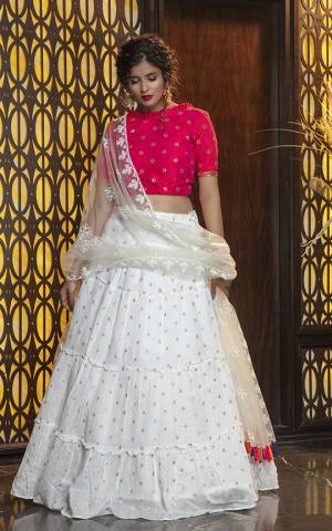 Here Is Lovely and Elegant Looking Designer Lehenga Choli In Rani Pink Colored Blouse Paired With White Colored Lehenga And Dupatta. Its Blouse Is Silk Based Paired With Cotton Fabricated Lehenga And Net Fabricated Dupatta. Buy Now.