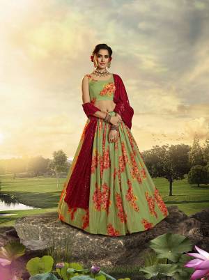 You Will Definitely Earn Lots Of Compliments Wearing This Designer Printed Lehenga Choli In Green Color Paired With Red Colored Dupatta. This Lehenga Choli Is Orgenza Based Paired With Georgette Fabricated Sequence Embroidered Dupatta. 