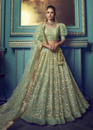 Get Ready For The Upcoming Wedding and Festive Season Wearing This Heavy Designer Lehenga Choli In Light Green Color. Its Blouse And Lehenga Are Fabricated On Net Beautified With Heavy Attractive Embroidery. 