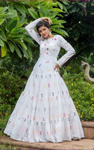 Celebrate This Festive Season Wearing This Designer Floor Length Gown In White Color Fabricated On Cotton Beautified With Prints. Buy This Semi-Stitched Gown Now.